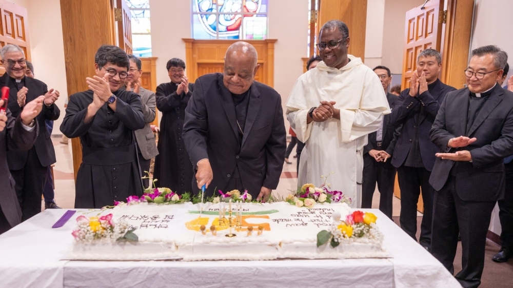 After celebrating a Mass on Sept. 29, 2024 marking the 50th anniversary of St. Andrew Kim Parish in Olney, Maryland, that serves Korean Catholics, Washington Cardinal Wilton Gregory cut an anniversary cake. Standing beside the cardinal at left is Father Matthew Park, St. Andrew Kim’s pastor, and to the cardinal’s right is Dominican Father Raymond Nwabueze, a parochial vicar at nearby St. Peter Parish in Olney. Applauding at the far left is Father Emanuel Magro, another parochial vicar from St. Peter Parish, and applauding at the far right is Father Paul Lee, the pastor of the Shrine of St. Jude in Rockville, Maryland. (Catholic Standard photo by Mihoko Owada)